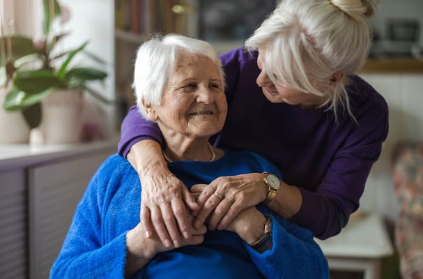 Caregiver interacting warmly with a senior resident