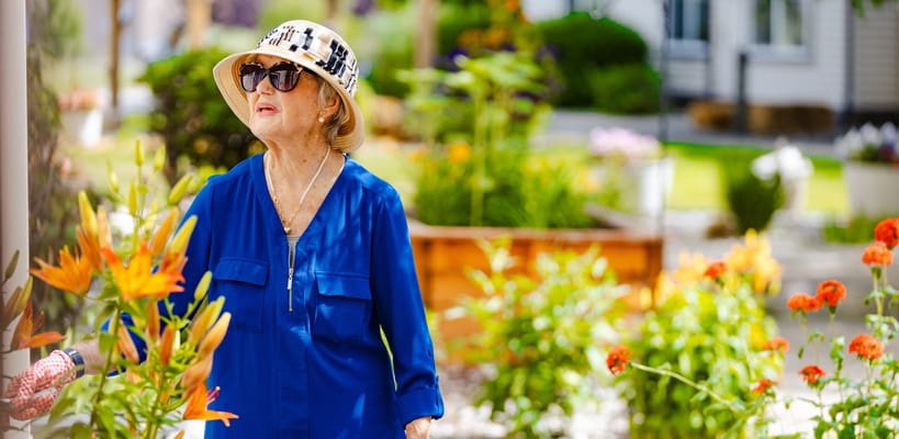 A woman enjoying colorful flowers in a garden