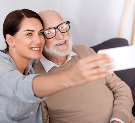 Caregiver and resident taking a selfie together