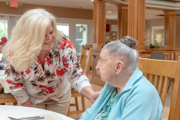 Staff member interacting with a resident in a common area