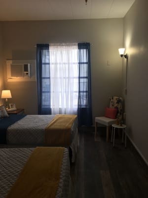 Cozy resident bedroom with two beds and window view