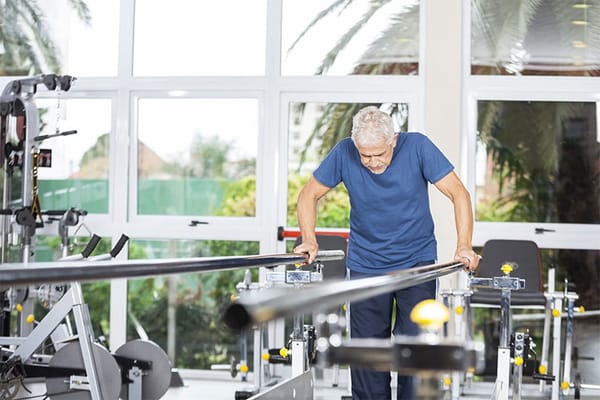 Senior man exercising in a bright gym