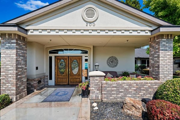 Front entrance of a senior living facility with flowers
