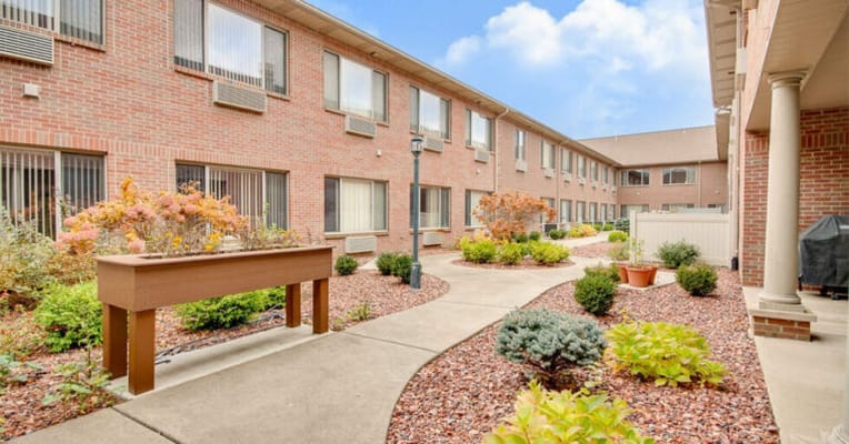 Garden pathway with colorful plants and seating