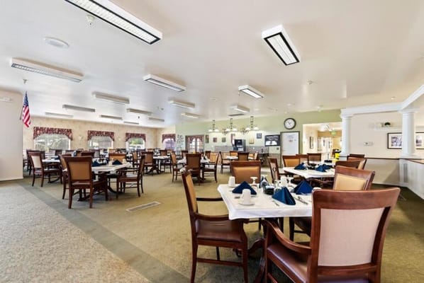 Dining room with tables set for residents