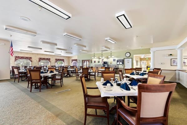 Dining room with tables set for residents