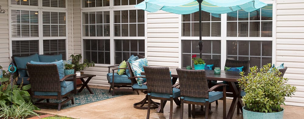 Outdoor patio area with seating and an umbrella