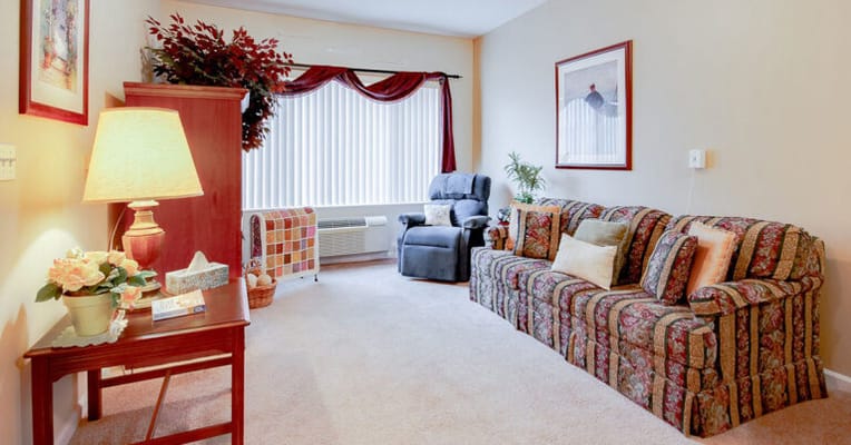 Cozy living room with a floral sofa and lamp