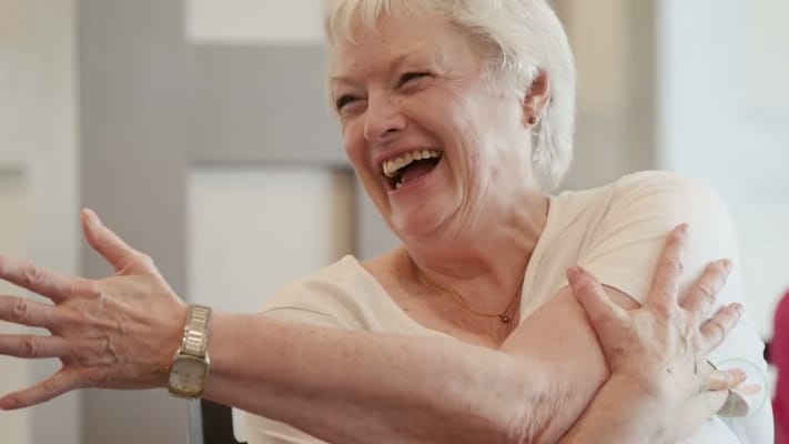 Resident smiling during a joyful group activity