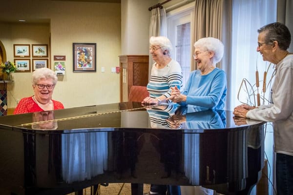 Residents enjoying music at the piano