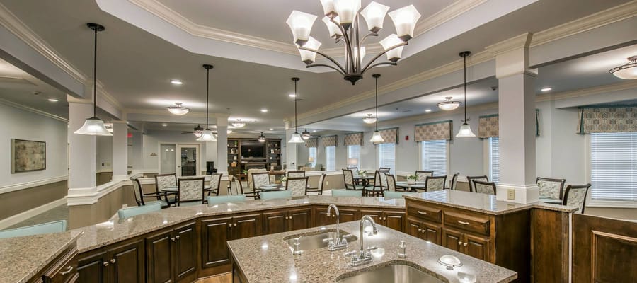 Bright common area with seating and decorative lighting