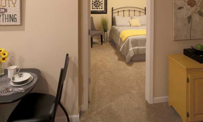 Cozy resident room with bed and dining space