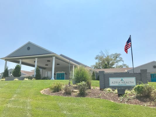 Exterior view of Azria Health facility with flag