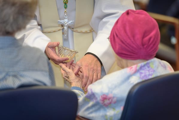 Resident receiving communion during a service