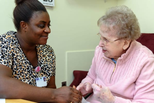 Caregiver interacting with a resident in a cozy setting