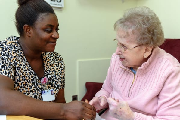 Caregiver interacting with a resident in a cozy setting