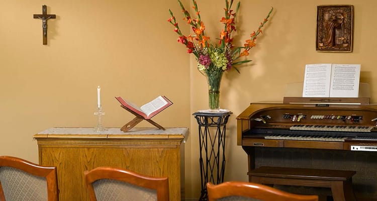 A serene interior space with a music organ and flowers
