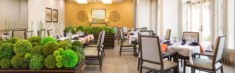 Elegant dining room with green decor and table settings