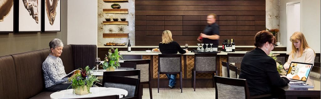 Residents enjoying drinks in a stylish common area