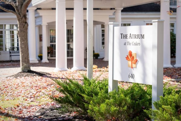 Sign for The Atrium facility surrounded by autumn foliage
