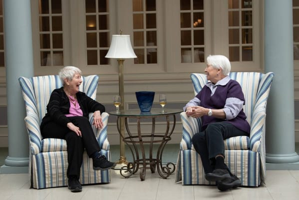 Two residents enjoying conversation in a common area