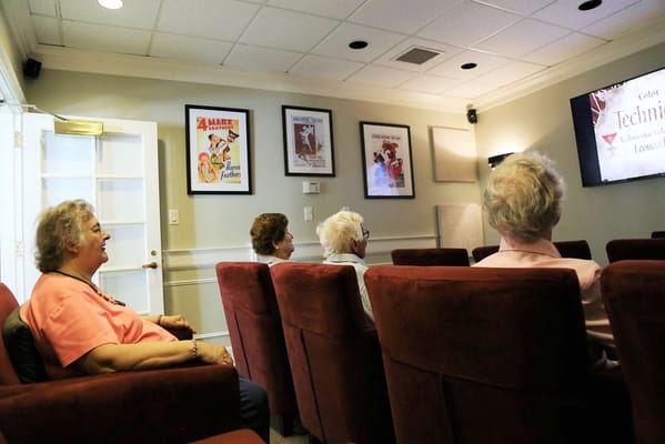 Residents watching a movie in a cozy common area