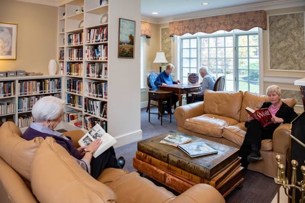 Residents reading in a cozy library area