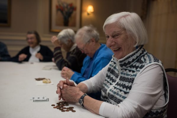 Residents enjoying a game at a large table