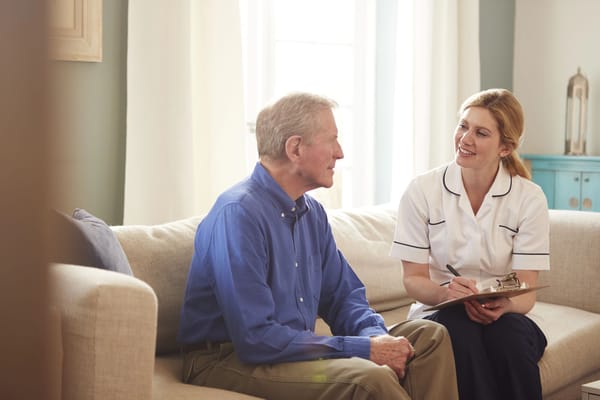 A caregiver conversing with a resident in a cozy living area