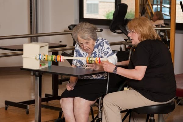 Therapist assisting a resident with an activity