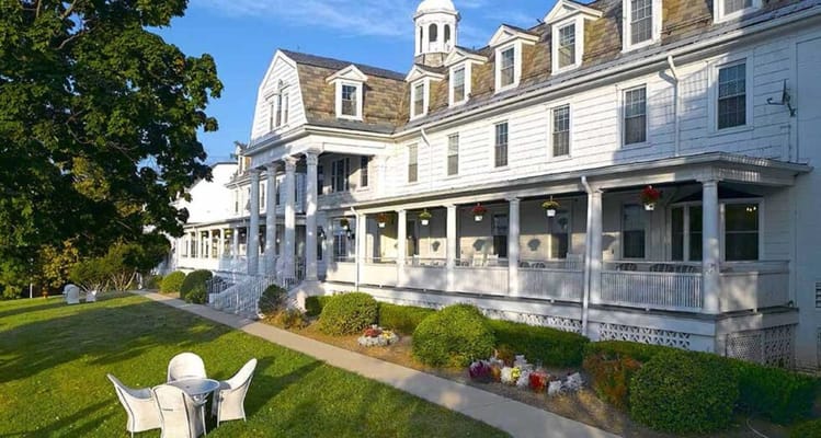 Exterior view of a senior living facility with gardens