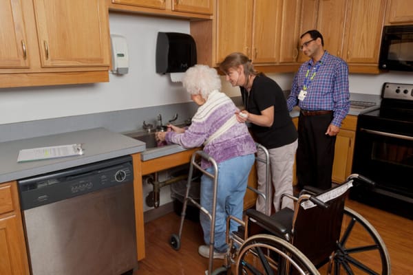 Staff assisting a resident in the kitchen
