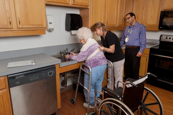 Staff assisting a resident in the kitchen