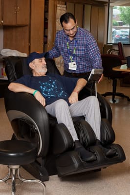 Staff assisting resident in a therapeutic recliner