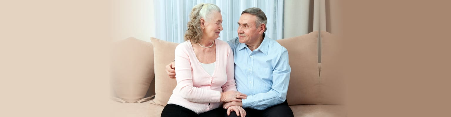Senior couple enjoying each other's company on a couch