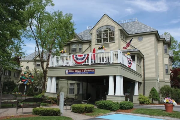 Exterior view of assisted living facility with patriotic decorations