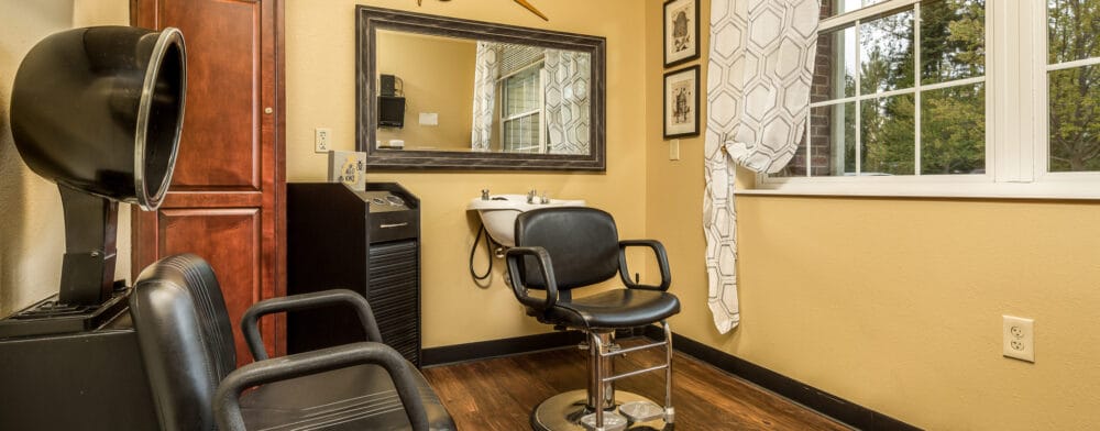 Interior view of a hair salon with chairs and sink