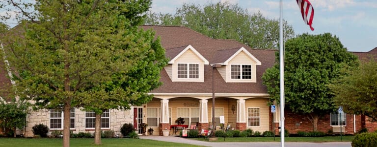 Exterior view of the senior living facility with landscaping