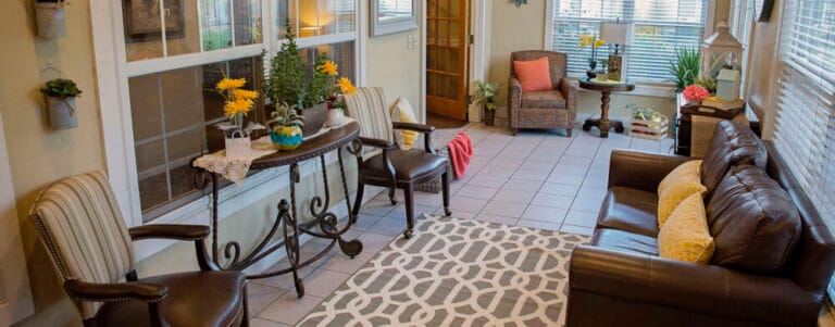 Bright common area with comfortable seating and plants