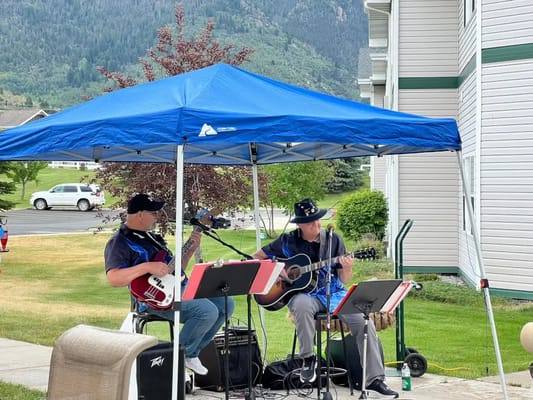 Musicians performing under a tent outside the facility