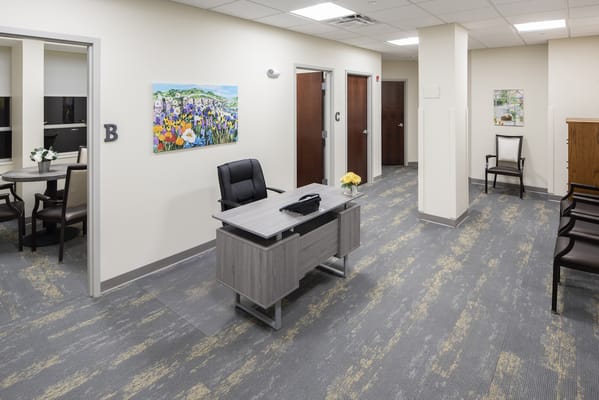 Modern reception area with a desk and artwork