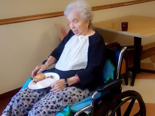 Resident enjoying a meal in a dining area