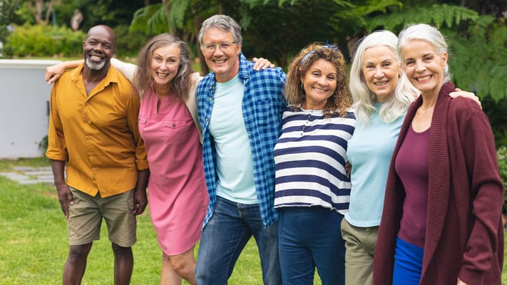 A group of smiling residents enjoying the outdoors