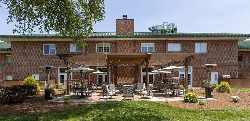 Outdoor patio area with seating and greenery