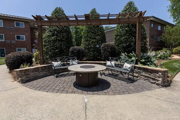 Outdoor seating area with decorative benches and landscaping