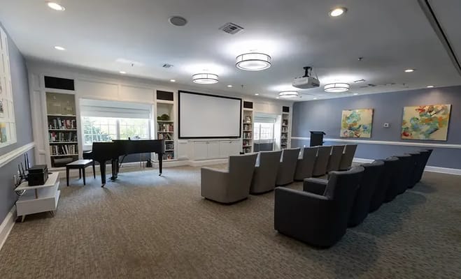 Interior of a multi-purpose activity room with seating and piano