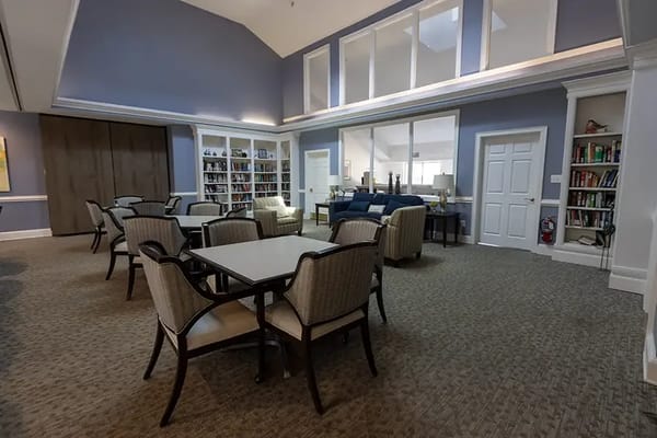Bright common area with comfortable seating and bookshelves