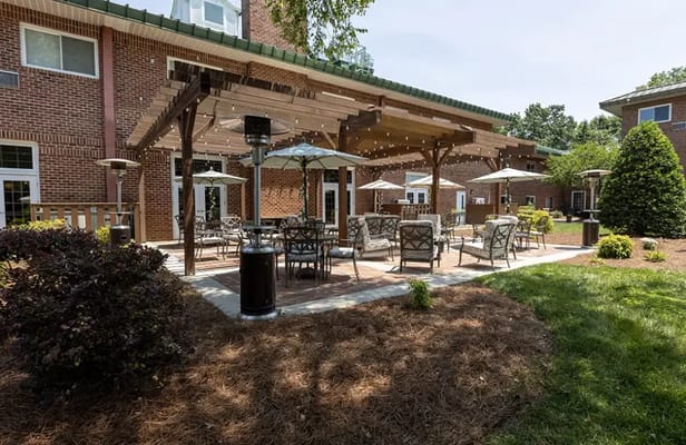 Outdoor seating area with umbrellas and landscaping