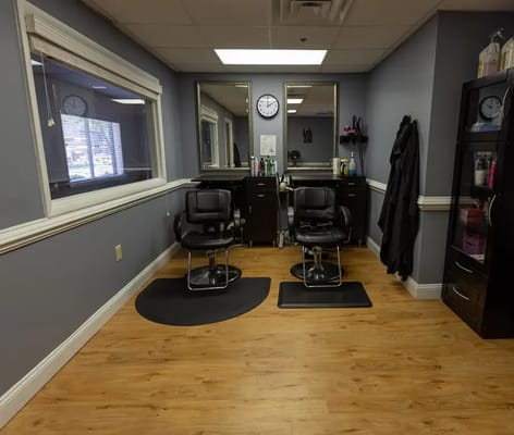Interior view of a beauty salon with chairs and mirrors