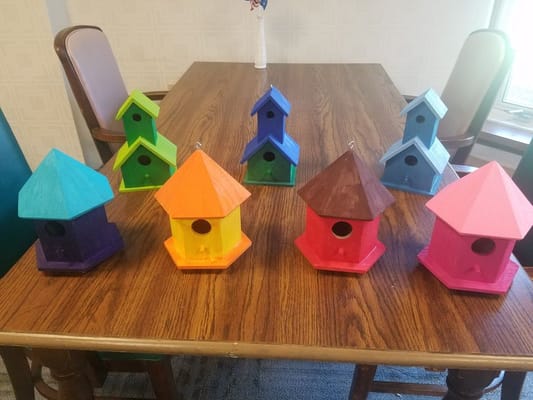 Colorful birdhouses displayed on a table
